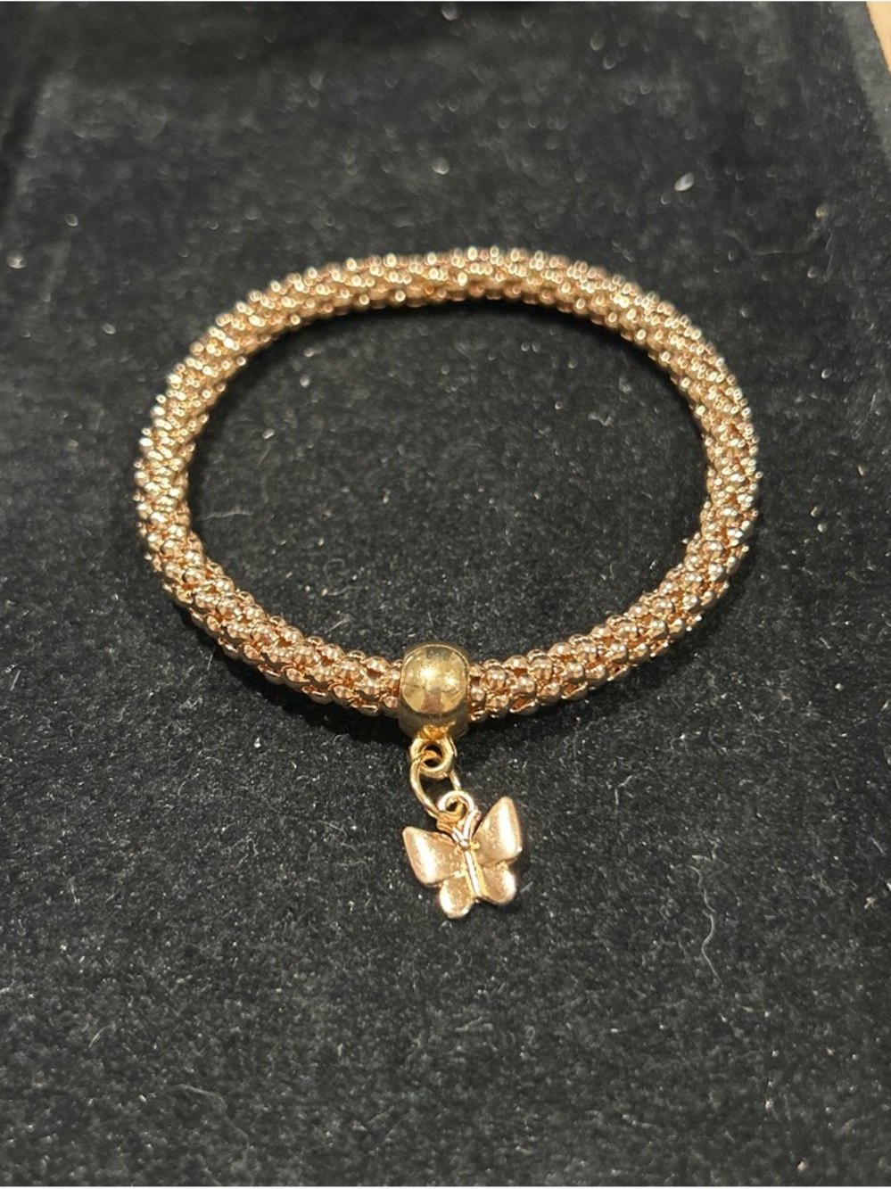 Gold color stretch bracelet with butterfly charm